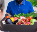 delivery-man-wearing-face-mask-holding-box-with-vegetables_1268-14611